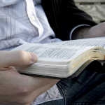 Hands holding a Bible